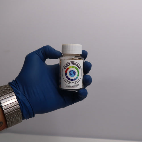 Hand wearing a blue glove holding a small bottle labeled 'Alkyworld' Mind & Memory Capsules